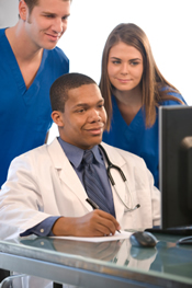 Doctor and staffers at computer
