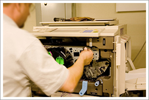 Copier repairman at work Copier repairman at work
