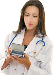 Physician using a small tablet computer Physician using a small tablet computer
