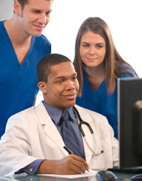 Doctor and two other staffers looking at computer Doctor and two other staffers looking at computer