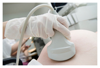 Ultrasound probe on pregnant belly Ultrasound probe on pregnant belly