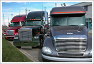 Three new semi tractors at a dealership